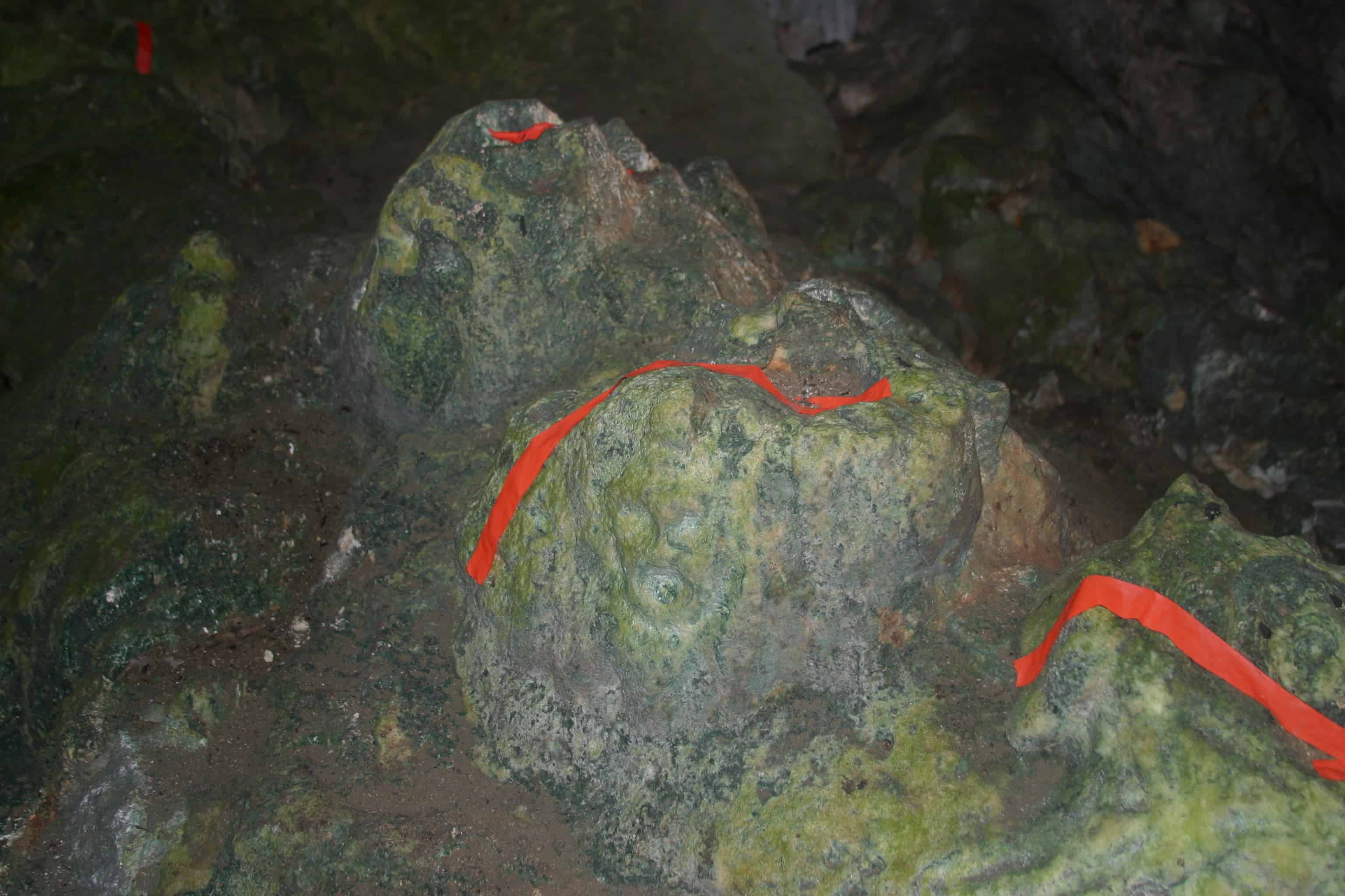 Ancient carving in Fountain Cavern (the red tape is simply to draw attention to the feature in the low light. Copyright: Dr Mike Pienkowski