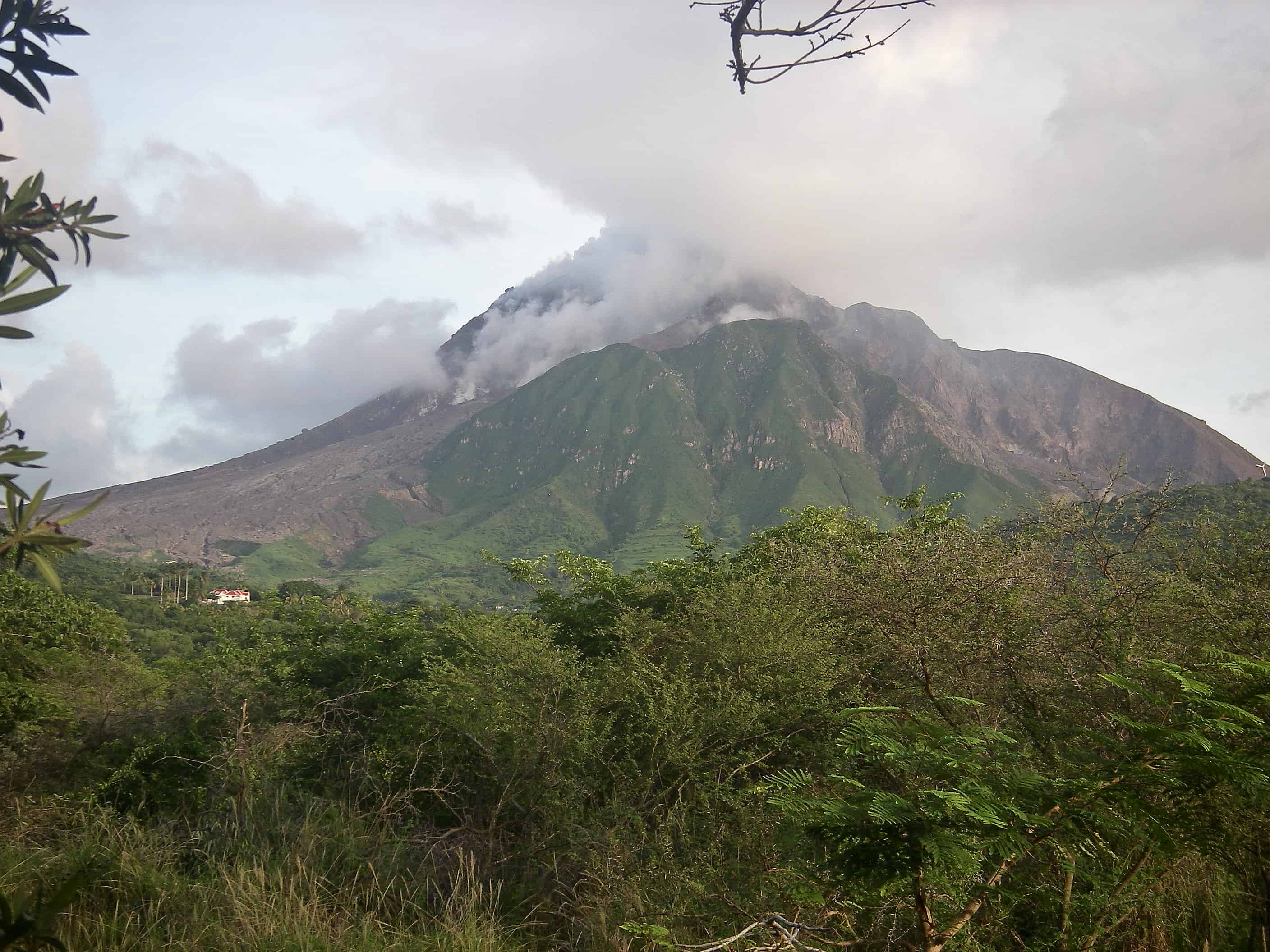 The Soufriere volcano in a still fairly active phase, with fumes from its flanks mixing with its almost permanent summit cloud. Copyright: Dr Mike Pienkowski