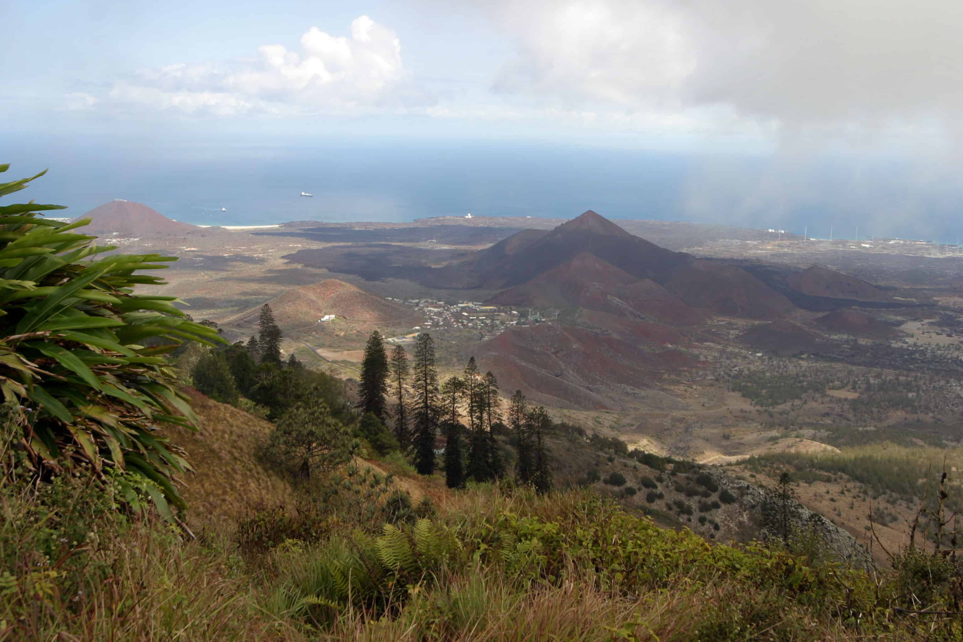 View from Green Mountain, with younger volcanic cones and Two Boats settlement in the middle ground and turtle beach in the distance; Copyright: Dr Mike Pienkowski 